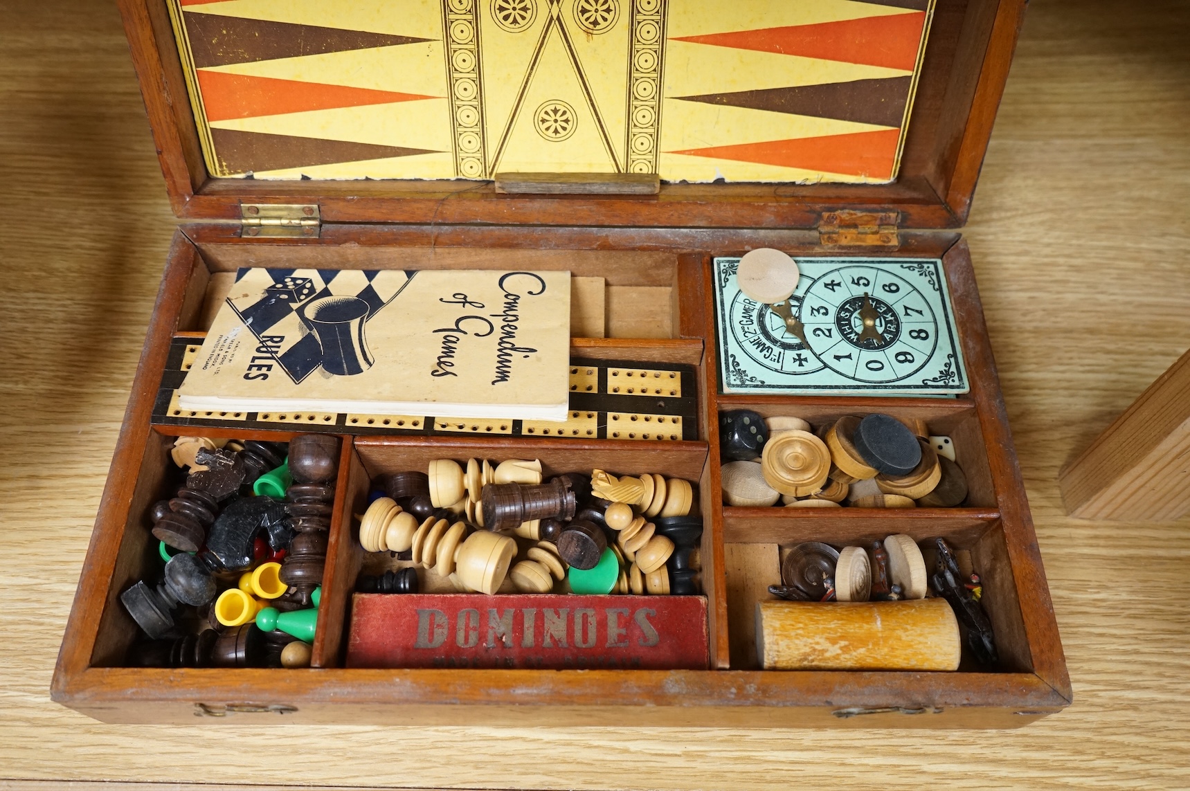 A wooden boxed games compendium, 33cm wide x 19.5cm deep